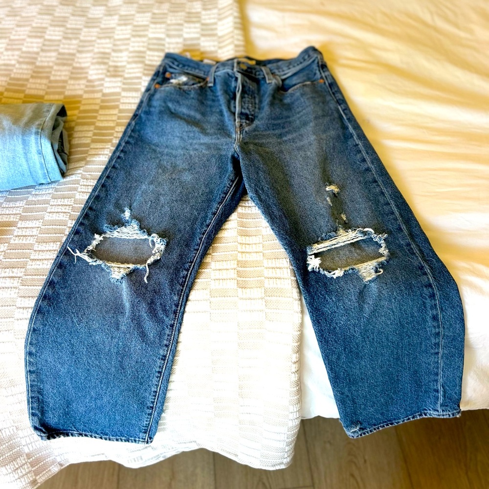 Blue jeans with holes.